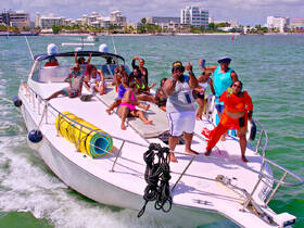 A lively group enjoys a fun-filled day on a boat, celebrating with drinks and laughter — the perfect atmosphere for a memorable party on the water.