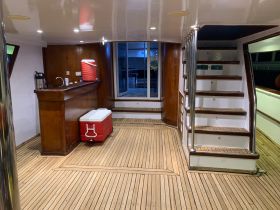 Interior view of a boat's cabin featuring a bar area and seating, showcasing a cozy space perfect for relaxation and socializing on the water.