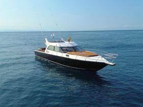 A sleek yacht cruising through calm waters, showcasing its elegant design and perfect for luxury outings on the sea.