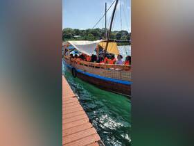 A lively group of guests wearing life jackets enjoys a boat ride, showcasing the fun and excitement of water adventures.