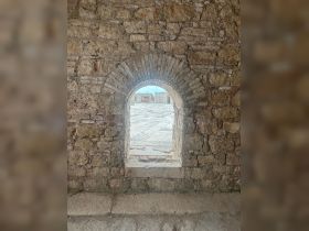 An unclear view through an archway in a stone structure, lacking identifiable subjects or context.