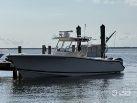 A sleek speedboat docked at the marina, showcasing its modern design and ready for a day on the water.