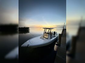 A sleek speedboat docked at sunset, reflecting the serene waters — perfect for fishing trips or leisurely cruises.