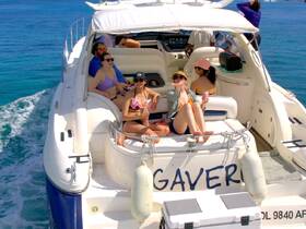 A lively group enjoys a sunny day on a yacht, celebrating with drinks and good company — perfect for a fun day on the water.