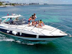 A lively group enjoys a fun day on a boat, celebrating with friends against a beautiful waterfront backdrop — perfect for summer outings and memorable gatherings.