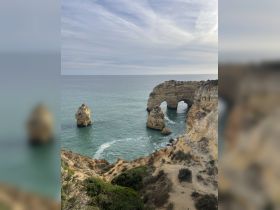 A stunning view of natural rock formations along the coastline, showcasing the beauty of the ocean and cliffs — perfect for scenic boat tours and exploration.