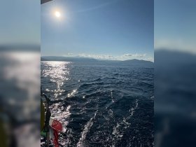 A serene view of the open sea with sunlight reflecting off the water, showcasing the beauty of a sailing adventure.