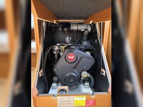 Close-up view of a boat engine compartment, showcasing essential components and maintenance information — crucial for understanding onboard mechanics.