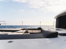 A serene view of the interior seating area on a yacht, showcasing the comfortable design against a backdrop of the open sea.