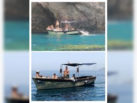 A lively group enjoys a day on the water aboard a boat, showcasing fun and relaxation in a beautiful coastal setting.