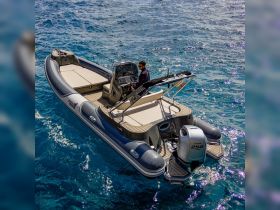 A sleek speedboat navigates through clear waters, showcasing its modern design and spacious seating — perfect for thrilling adventures on the open sea.