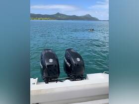 A couple enjoys swimming in the clear waters with a stunning mountain backdrop, showcasing the beauty of a tropical getaway.