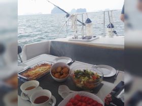 A beautifully arranged spread of delicious food aboard a boat, perfect for enjoying a meal while cruising the scenic waters.