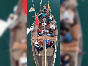 A lively group enjoys their time aboard a boat, showcasing camaraderie and fun in a picturesque setting.