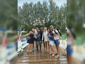 A cheerful group of friends gathers at the dock, ready for an exciting boating adventure. This moment captures the joy of camaraderie and anticipation for a day on the water.