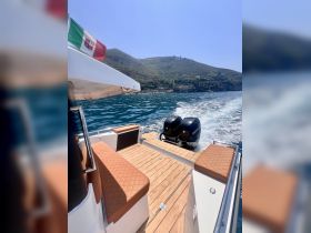 A stylish interior view of a boat showcasing comfortable seating and a sleek helm, perfect for enjoying a day on the water.