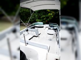 A clean and spacious interior view of a boat's helm and seating area, showcasing modern design and comfort for an enjoyable day on the water.