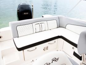 A stylish interior seating area of a Sea Ray boat, showcasing comfortable cushions and a sleek design, perfect for relaxing on the water.