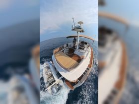 Aerial view of a luxurious yacht in motion, showcasing its sleek design and spacious deck, perfect for a day on the water.