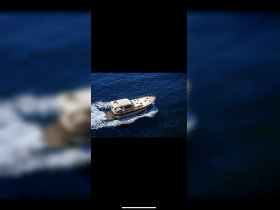 Aerial view of a sleek boat cruising through deep blue waters, showcasing its elegant design and perfect for scenic outings.