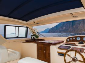 Interior view of a luxurious boat helm, showcasing elegant design and a stunning ocean backdrop — perfect for navigating beautiful waters.