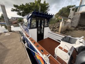 A detailed view of the helm and interior of a well-equipped boat, showcasing the stylish cabin and console area, perfect for comfortable cruising.