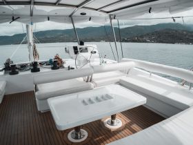 A sleek and modern interior view of a yacht's helm and seating area, showcasing the elegant design and functionality for a comfortable boating experience.