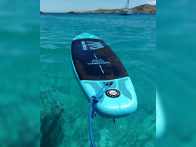 A vibrant paddleboard floats on crystal-clear waters, showcasing the perfect equipment for a day of fun on the water.
