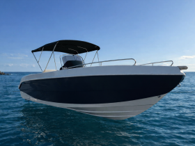 A sleek speedboat captured from the front, gliding through clear waters under a bright blue sky — perfect for thrilling adventures on the open sea.