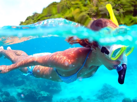 A snorkeler explores vibrant underwater scenery, showcasing the beauty of marine life and coral reefs — an unforgettable adventure in crystal-clear waters.