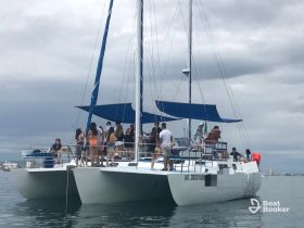 A lively group enjoys a day on a catamaran, showcasing the perfect setting for celebrations and fun on the water.