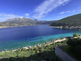 A breathtaking view of a serene coastline with crystal-clear waters and lush greenery, perfect for showcasing the natural beauty of the area.
