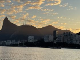 A stunning sunset view over the iconic Sugarloaf Mountain and the city skyline of Rio de Janeiro, showcasing the natural beauty and vibrant atmosphere of this famous destination.