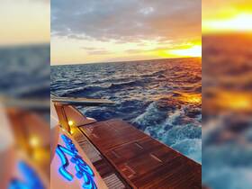 A stunning sunset view from the deck of a yacht, showcasing the beautiful ocean waves and warm colors of the sky — perfect for evening cruises.