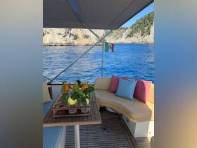 A beautifully arranged table with fresh fruits and glasses on a cozy seating area aboard a boat, perfect for enjoying refreshments while taking in the scenic views.