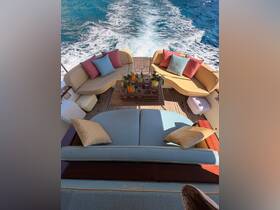 A beautifully arranged lounge area on a yacht, featuring plush seating and a stylish table with refreshments, perfect for relaxing while cruising on the open water.