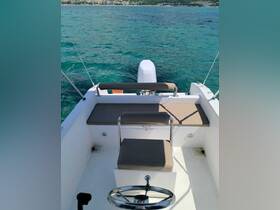 A clean and spacious interior view of a boat's helm and seating area, perfect for enjoying a day on the water.