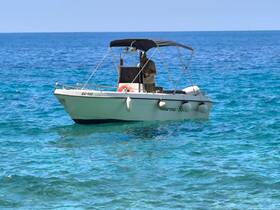 A speedboat navigates through crystal-clear waters, showcasing the perfect day for boating adventures.