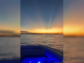 A stunning sunset view from the bow of a boat, showcasing the tranquil waters and vibrant colors of the sky — perfect for evening cruises.