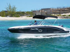A sleek speedboat named 'Sweet Thing' glides through crystal-clear waters, showcasing its stylish design and perfect for a day of adventure on the water.