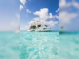 A stunning yacht anchored in crystal-clear waters, showcasing its sleek design and inviting atmosphere — perfect for luxurious getaways or water adventures.