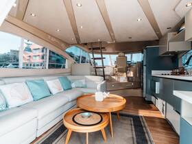 A beautifully designed interior of a yacht featuring a cozy lounge area with plush seating and modern amenities, perfect for relaxing on the water.