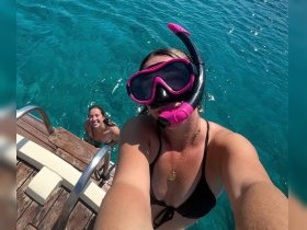 Two friends enjoy snorkeling in crystal-clear waters, capturing a fun moment together — perfect for adventure seekers and underwater exploration.