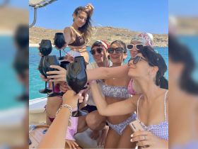 A lively group of friends toasts with cocktails on a boat, enjoying a fun-filled day on the water — perfect for celebrations and summer adventures.