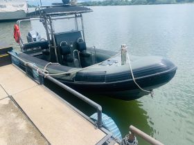 A sleek speedboat docked at the marina, showcasing its modern design and spacious seating — perfect for thrilling water adventures.
