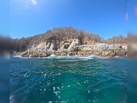 A stunning view of rocky coastline and clear turquoise waters, perfect for showcasing the natural beauty of the area.