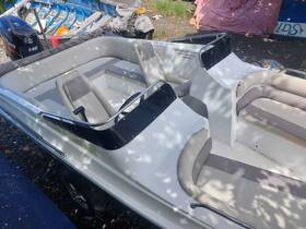 Interior view of a boat showcasing comfortable seating and helm area, perfect for relaxing on the water.