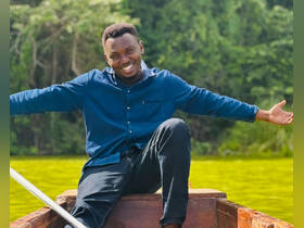 A joyful man enjoys a scenic boat ride surrounded by lush greenery, capturing the essence of outdoor adventures and relaxation on the water.