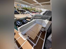 A cozy interior view of a boat's dining area featuring a stylish table and comfortable seating, perfect for enjoying meals while on the water.