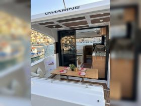 A beautifully designed interior of a yacht featuring a dining area with elegant table settings, perfect for intimate gatherings or meals on the water.